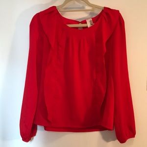 Francesca’s red ruffled blouse